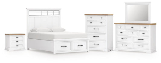 Cama Ashbryn King con cabecero, tocador con espejo, cómoda y mesita de noche.