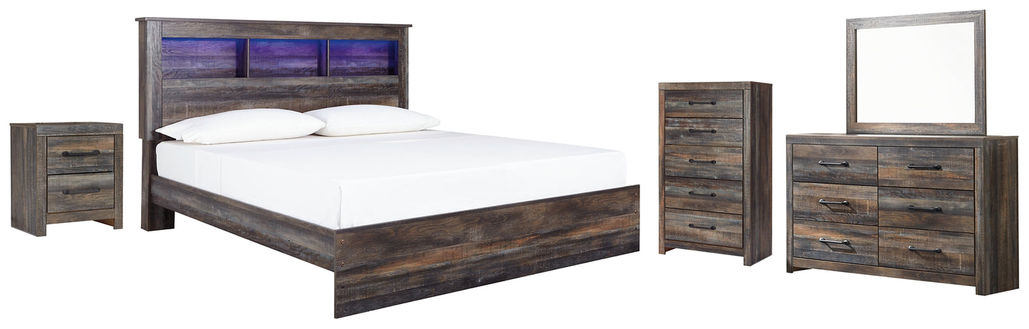 Cama Drystan King con librero, tocador con espejo, cómoda y mesita de noche.