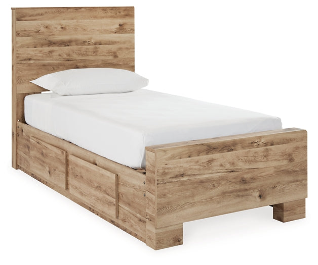 Cama individual Hyanna con almacenaje, tocador con espejo, cómoda y mesita de noche.