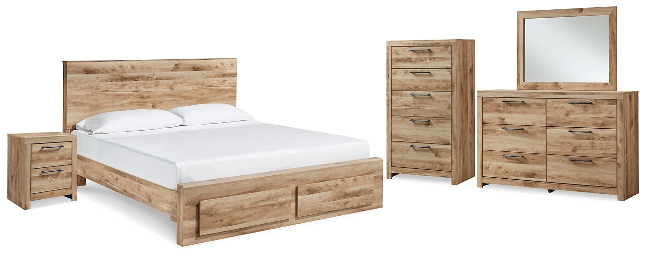 Cama Hyanna King con cabecero, tocador con espejo, cómoda y mesita de noche.