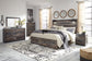 Cama Drystan tamaño King con cabecero y almacenaje, tocador con espejo, cómoda y mesita de noche.