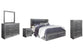 Cama Lodanna tamaño King con dos cajones, tocador con espejo, cómoda y mesita de noche.