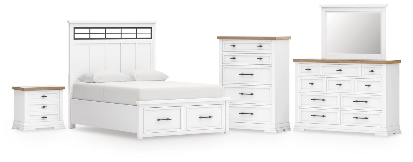 Cama Ashbryn King con cabecero, tocador con espejo, cómoda y mesita de noche.