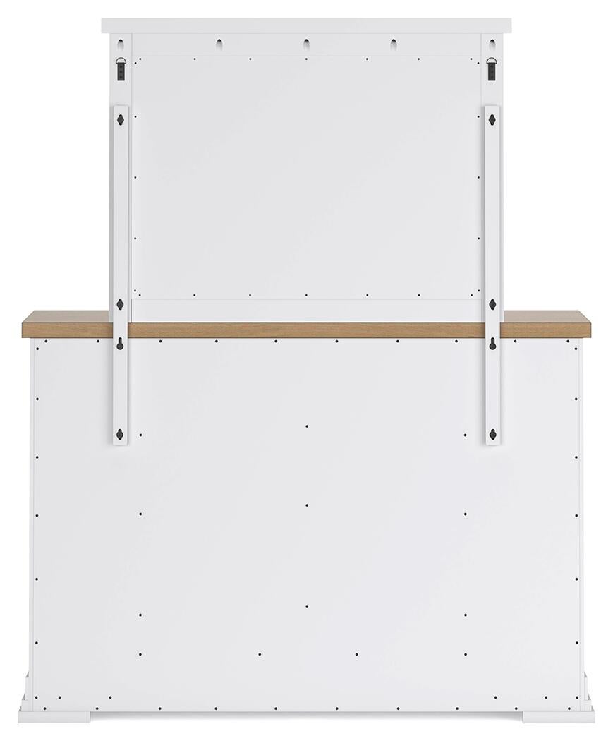 Cama Ashbryn King con cabecero, tocador con espejo, cómoda y mesita de noche.