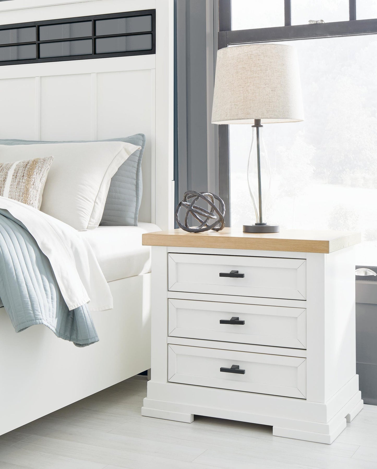 Cama Ashbryn King con cabecero, tocador con espejo, cómoda y mesita de noche.