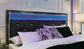 Kaydell King Upholstered Panel Storage Platform Bed with Mirrored Dresser